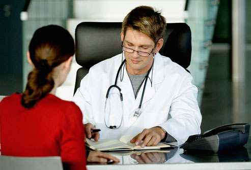 Fibromyalgia: Getting Treatment woman at doctors desk